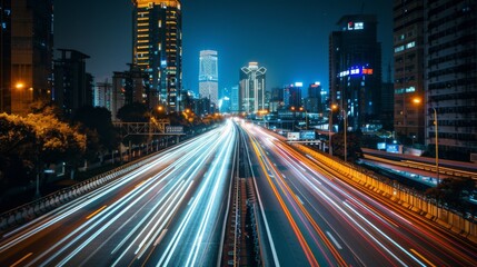Obraz premium Nighttime long exposure of a road. A vibrant long exposure shot capturing the dynamic lights of cars traversing a road at night, reflecting the urban pulse