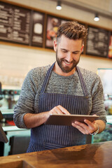 Happy, man and barista with tablet in cafe for restaurant sales, discounts and reviews on website...