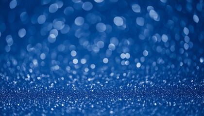 Shiny sapphire glittery bokeh with blue colors sparkling festive light spotted backdrop.