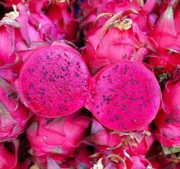 Exotic Dragon Fruit: A Vibrant Delight. The Vivid Pink Flesh and Black Seeds of a Freshly Cut Pitaya