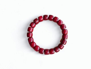 The white background in the picture is a bracelet and necklace made from wood that has been carved and decorated, painted with holes, then strung into lines to be used as jewelry to wear for beauty.