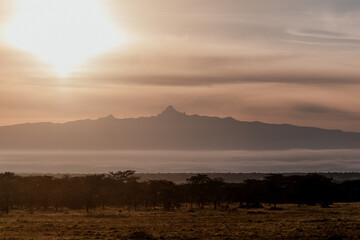 Dawn breaks over misty Ol Pejeta with Mount Kenya