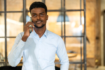 African cheerful man enjoys a lively conversation on his mobile phone, modern communication, the joy of connection, and the simplicity of daily life,technology in everyday life