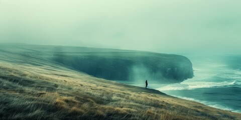 Person standing alone on a cliff overlooking a rough sea - Powered by Adobe