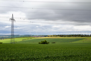 Power lines on a field and wind generators
