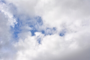 white clouds with a gap of blue sky in clouds   