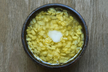 Tao suan , Sweet thai mung  bean pudding with coconut milk topping  in wooden bowl  .  Soybeans pudding  in the  black bowl . Thai desserts