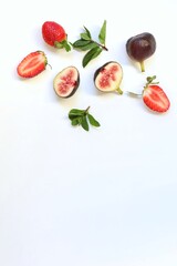 Figs and strawberries, in section, on a white background, fruits, berries, free space, place for text, top view, background