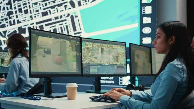 Indian operator transmitting gps coordinates for couriers to deliver orders, following awb information and satellite map to avoid traffic. Employee sending directions and cargo location. Camera B.
