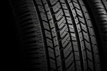 A close up of a black tire with the tread showing
