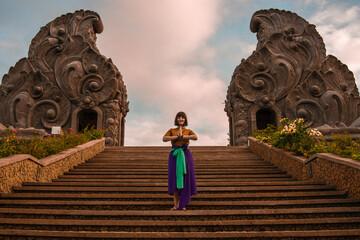 Woman posing on a deserted temple entrance
