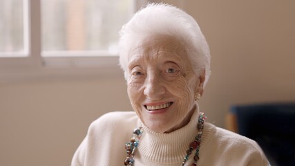 Old woman smiling at camera in a geriatric