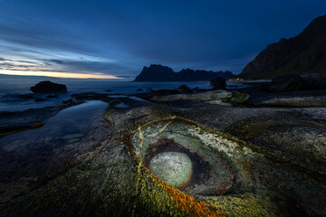 Famous rock formation called Dragon's Eye captured during dusk. Lamp lit stone in the natural pool...