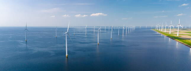 A vast body of water in Flevoland, with numerous towering windmills dotting the landscape