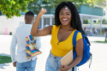 Cheering african american female student with successful test result