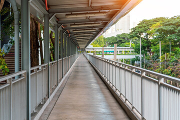 Sheltered walkway of an overhead bridge in a residential neighborhood.