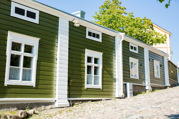 Porvoo, Finland. Narrow streets of Old town of Porvoo. Picturesque colorful wooden houses. Historic center, touristic place, landmark of Finland. Warm sunny summer day in nordic country.