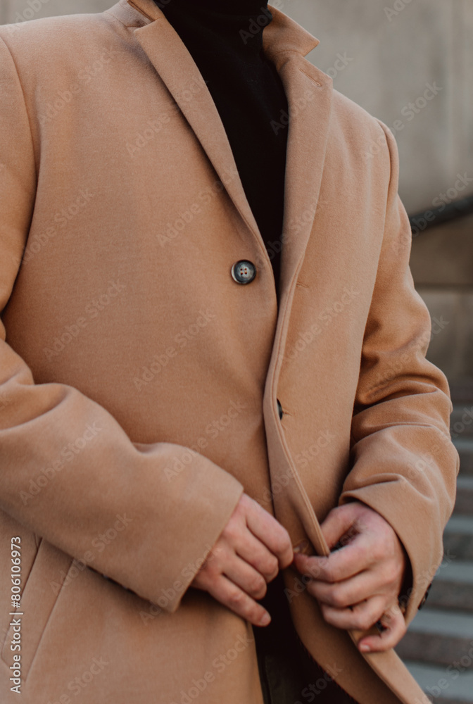 Wall mural Stylish details of brown beige men's coat and black turtleneck. Classic street outerwear