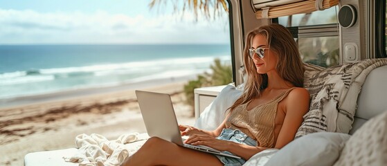 Relaxing and using her laptop while seated in an RV is a pleasure for the woman. The backdrop is the beach.