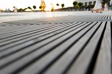 texture of a wooden street bench against the background of a summer park.