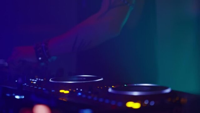 A person is playing a DJ set with two turntables