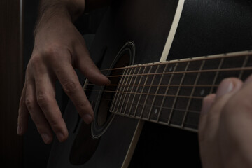 Shot of an artist's hands playing an acoustic guitar