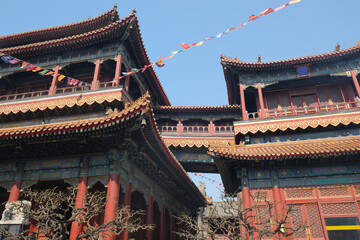 Chinese temple and flags against blue sky	