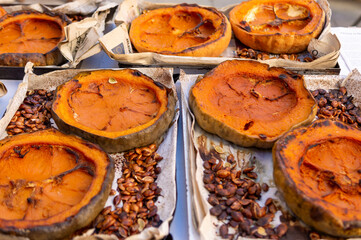 A pile of pumpkin pies with a paper wrapper on top
