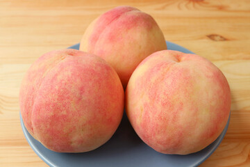 Closeup of Fresh Ripe Peaches on Wooden Table