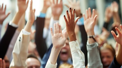 A diverse crowd of people raising their hands in excitement and joy at a public event, expressing enthusiasm and support