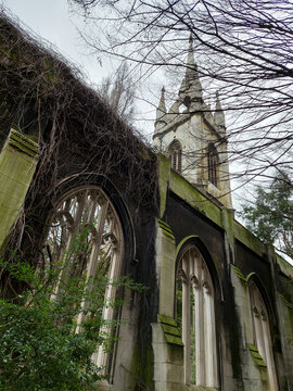 Old ruins overgrown by vegetation. Church building.