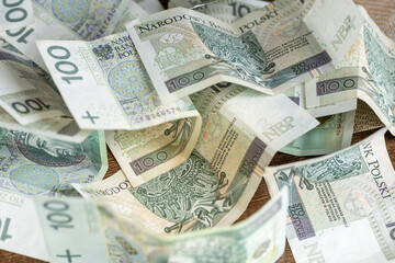 Poland finances, Polish money, 100 zloty banknotes scattered on the table, economic and budget...