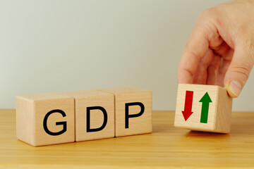 Gross domestic product concept.GDP written on wooden blocks, Down arrow symbol icon. monetary policy, Financial, Management, Economic, Inflation, Business and growth of GDP