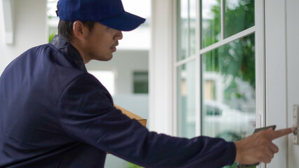 A delivery man in a cap presents a package to customer at home.
