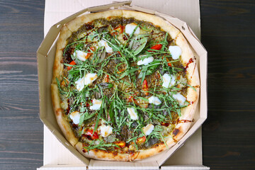 Delectable Margherita Pizza Topped with Arugula and Balsamic in a Paper Box