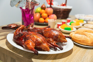 Glazed Peking Ducks Taking Center Stage on a Festive Vietnamese Table Spread