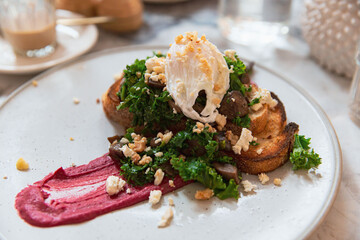 Toasted Sourdough Topped with Kale, Mushrooms, Poached Egg, Beetroot Purée for a Healthy Brunch