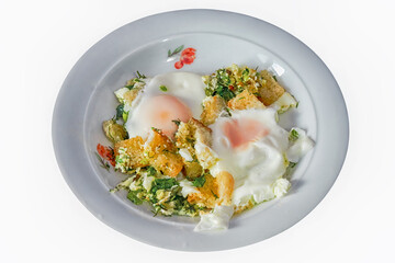 Scrambled eggs with croutons and herbs on a plate, isolate on a white background.