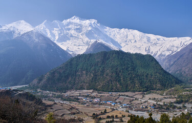 Panoramic view on the village Lower Pisang and the summit of the Annapurna II as seen from the...