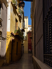 Empty, narrow street in the center of the old town. Facade of historic old buildings.