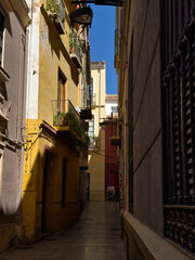 Empty, narrow street in the center of the old town. Facade of historic old buildings.