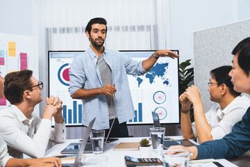 Analyst team utilizing BI Fintech to analyze financial data at table in meeting room....