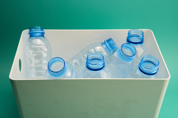 Recycled empty plastic bottles in white container