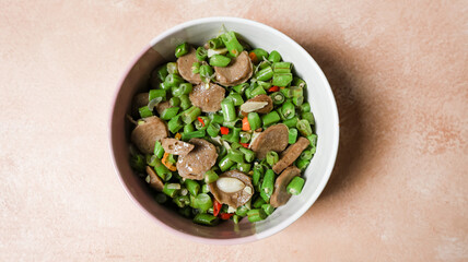 Stir-fried beans in a bowl placed on the table. Top Angle. Close up.