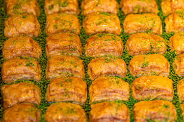 Turkish Pakhlava dessert. Close up of sweet turkish delishes for sale in a market stall in Istanbul, Turkey. Selective focus