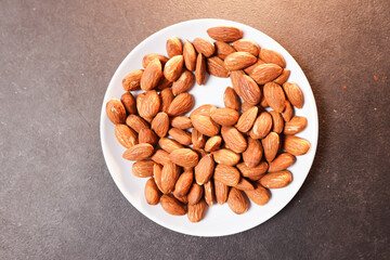 A bunch of almonds placed on a white plate