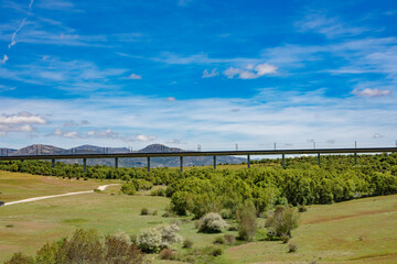 A front view of a road bridge in a blue sky background