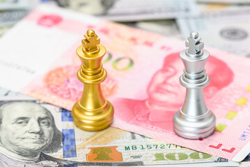 Two king chess games on US and Chinese currencies indicate a trade war and trade tensions, a confrontation between two major countries in which the US imposes high tariff rates on Chinese exports.