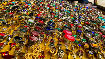 Colorful rings stones Beautiful jewelry of different types of stones. antique silver rings, multi colored Precious stones rings selling in a market.