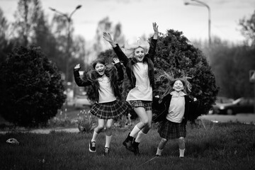 Portrait of a young mother and two beautiful daughters outdoors. Black and white photo.